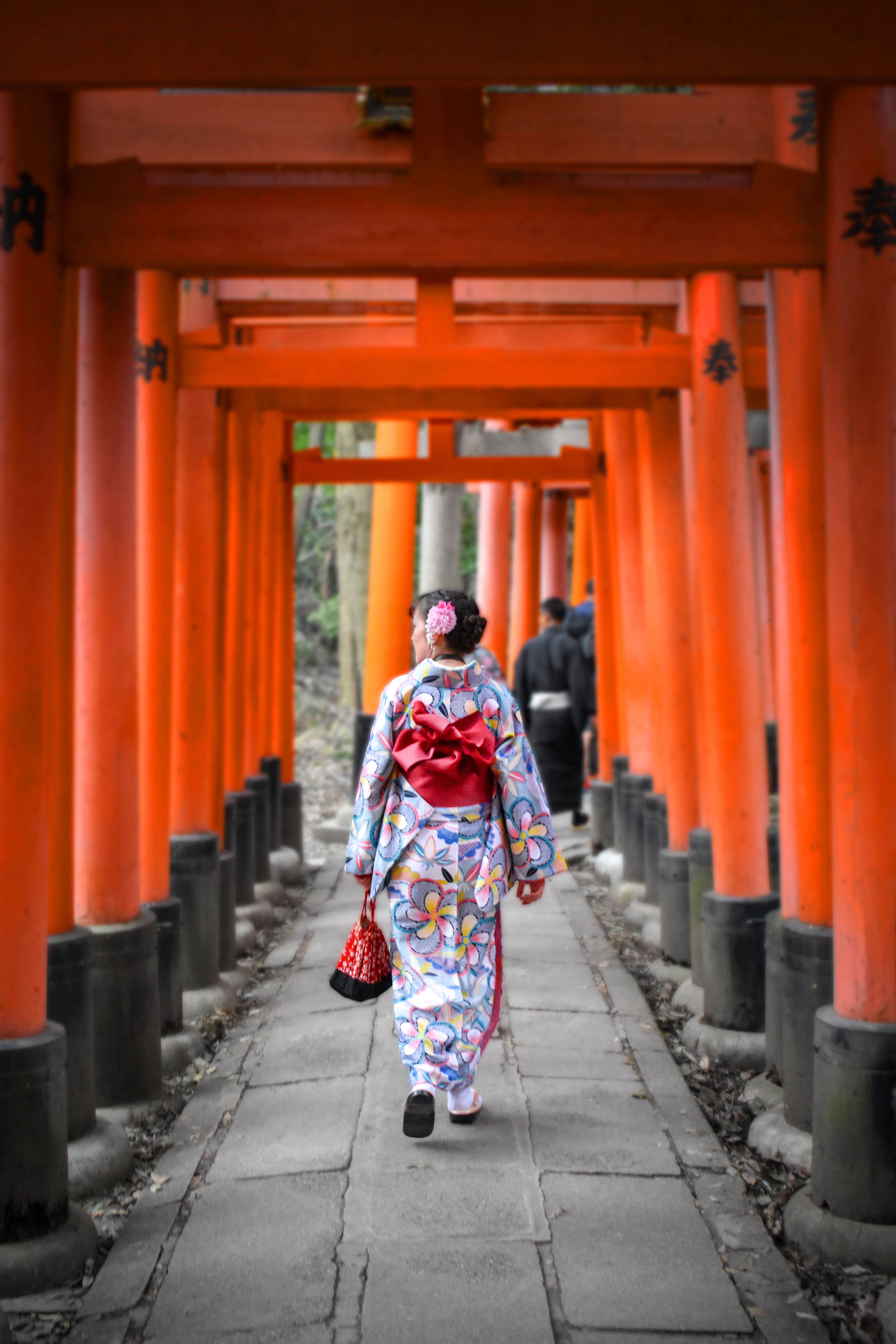Person in Kimono Walking Through Torii Gates in Kyoto · Free Stock Photo