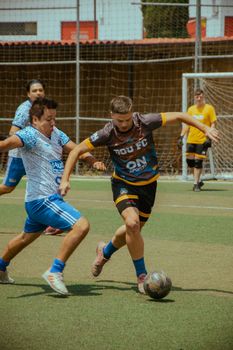 Intense soccer game between teams on an outdoor field, showcasing athletic skill and teamwork.