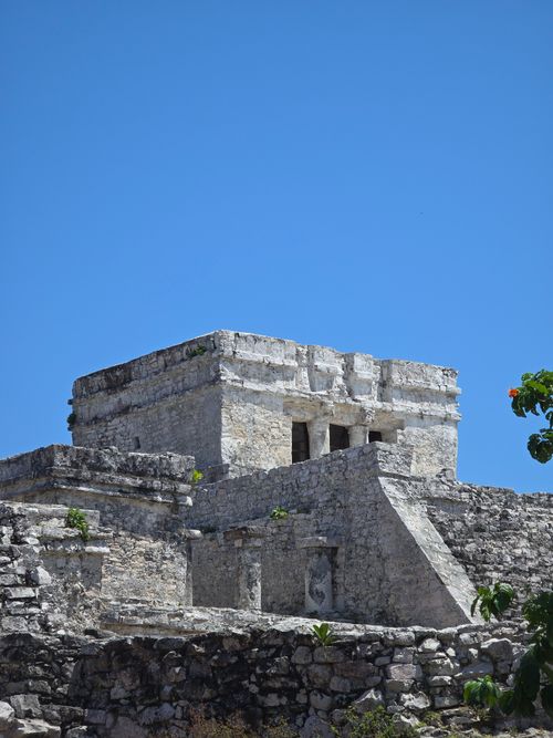Free Explore the rugged stone architecture of Mayan ruins against a vibrant blue sky in Tulum. Stock Photo