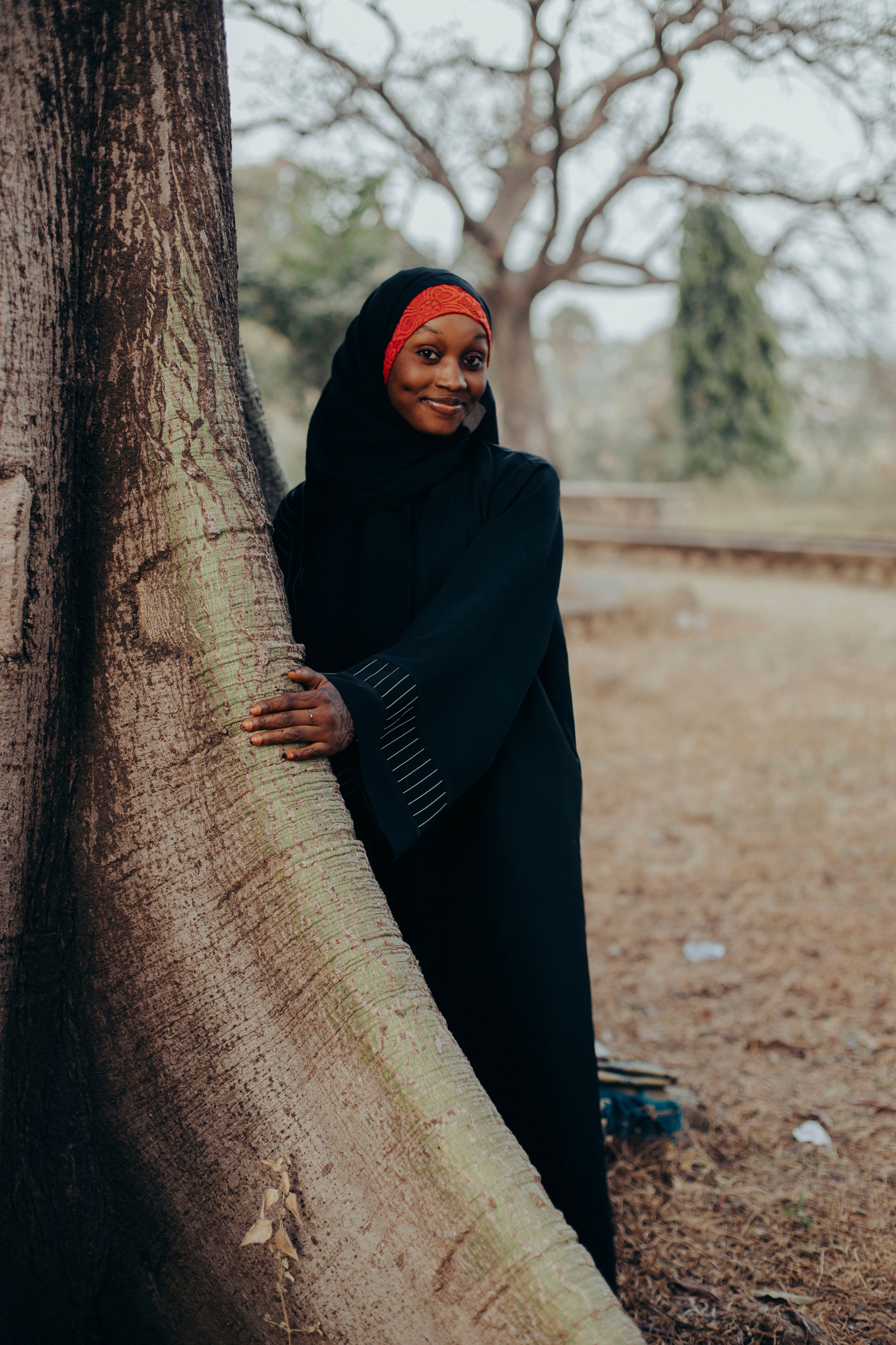 Young Woman in Black Hijab Smiling Outdoors · Free Stock Photo