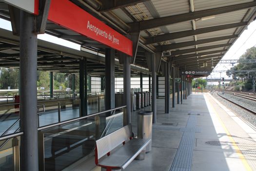 Modern design of Jerez de la Frontera airport train station platform under bright daylight.