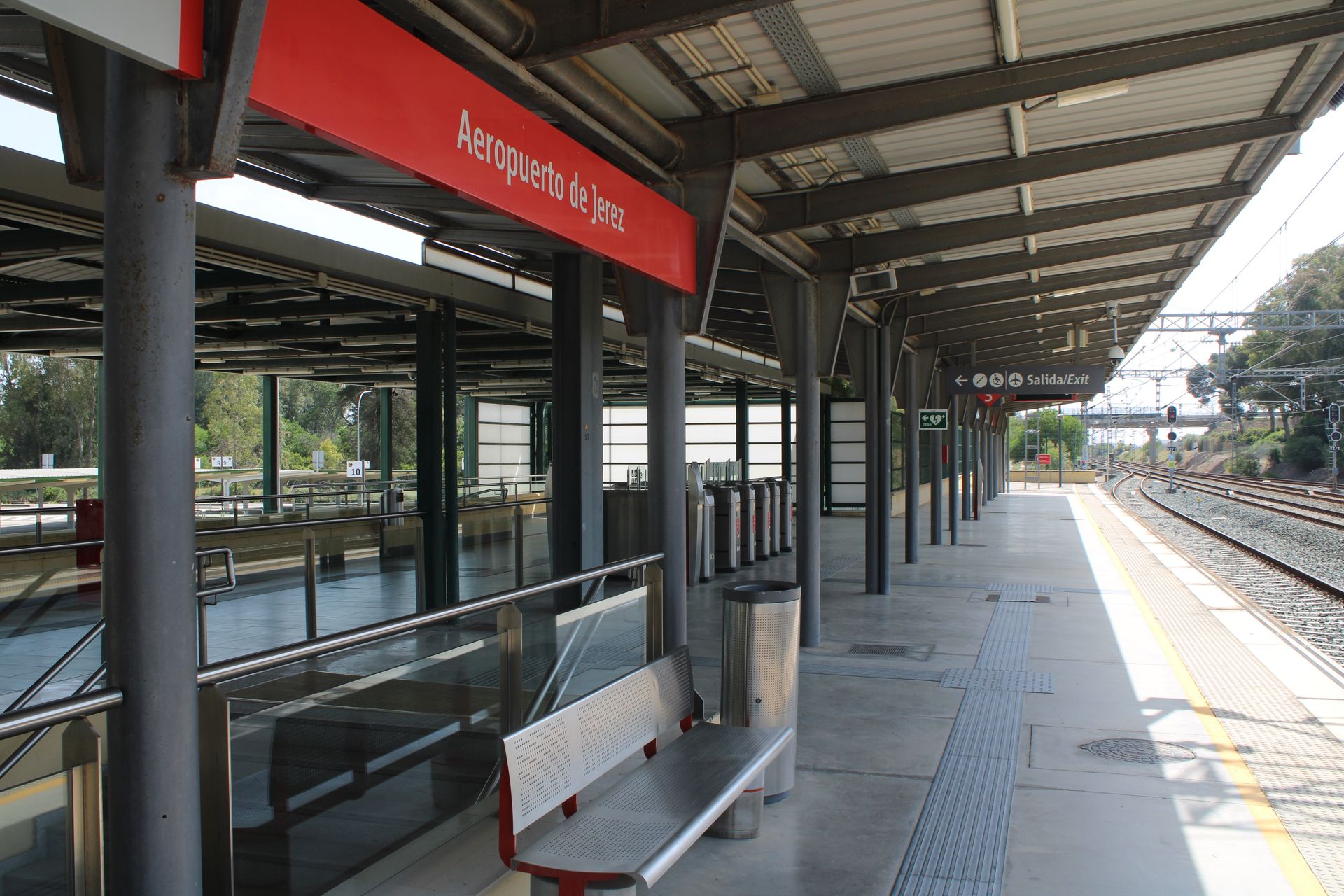 Modern design of Jerez de la Frontera airport train station platform under bright daylight.