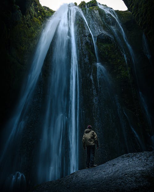 Free Photo Of Man Standing Near The Waterfalls Stock Photo