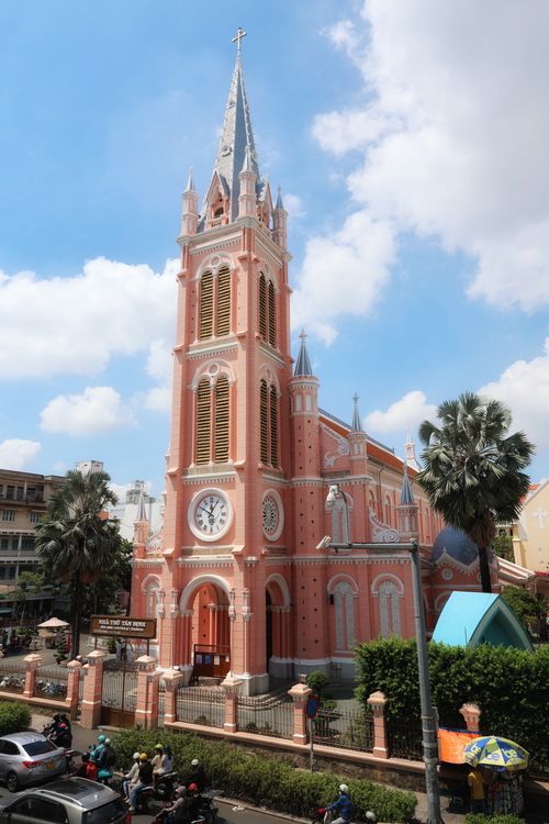 Free Striking pink cathedral with clock tower against a bright sky in an urban setting. Stock Photo