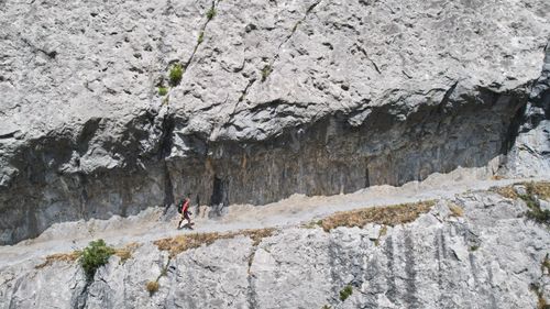 Free A solo hiker walks along a rocky path in the Pyrenees, France, under bright daylight. Stock Photo