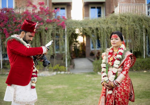 Bride and groom during a vibrant South Asian wedding photo shoot outdoors.