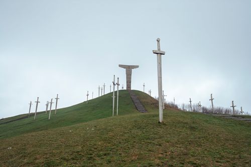 Free A serene landscape of wooden crosses on a green hillside in Mtskheta-Mtianeti, Georgia. Stock Photo