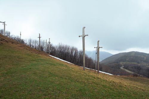 Free Sword monuments line a grassy hillside in Mtskheta-Mtianeti, Georgia, under a cloudy sky. Stock Photo