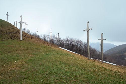 Free Eerie mist surrounds a hillside adorned with wooden crosses in Mtskheta-Mtianeti, Georgia. Stock Photo