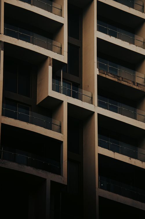 Free Close-up view of a modern building facade with geometric lines and shadows. Stock Photo