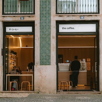 An inviting modern cafe with a minimalistic design and customers enjoying their visit.
