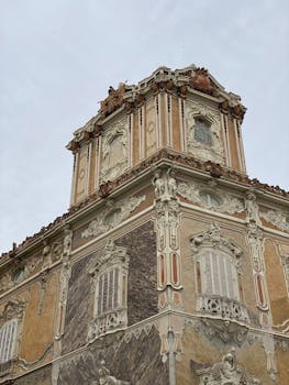 Detailed view of the elaborate baroque architectural style of Valencia's historic palace.