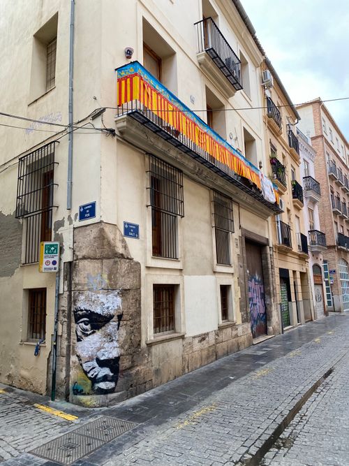 Free Colorful street art adorns a corner building in a European city, captured on a cloudy day. Stock Photo