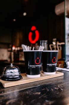 Atmospheric coffee shop in Baku featuring United Coffee cups and a subtle warm ambiance.