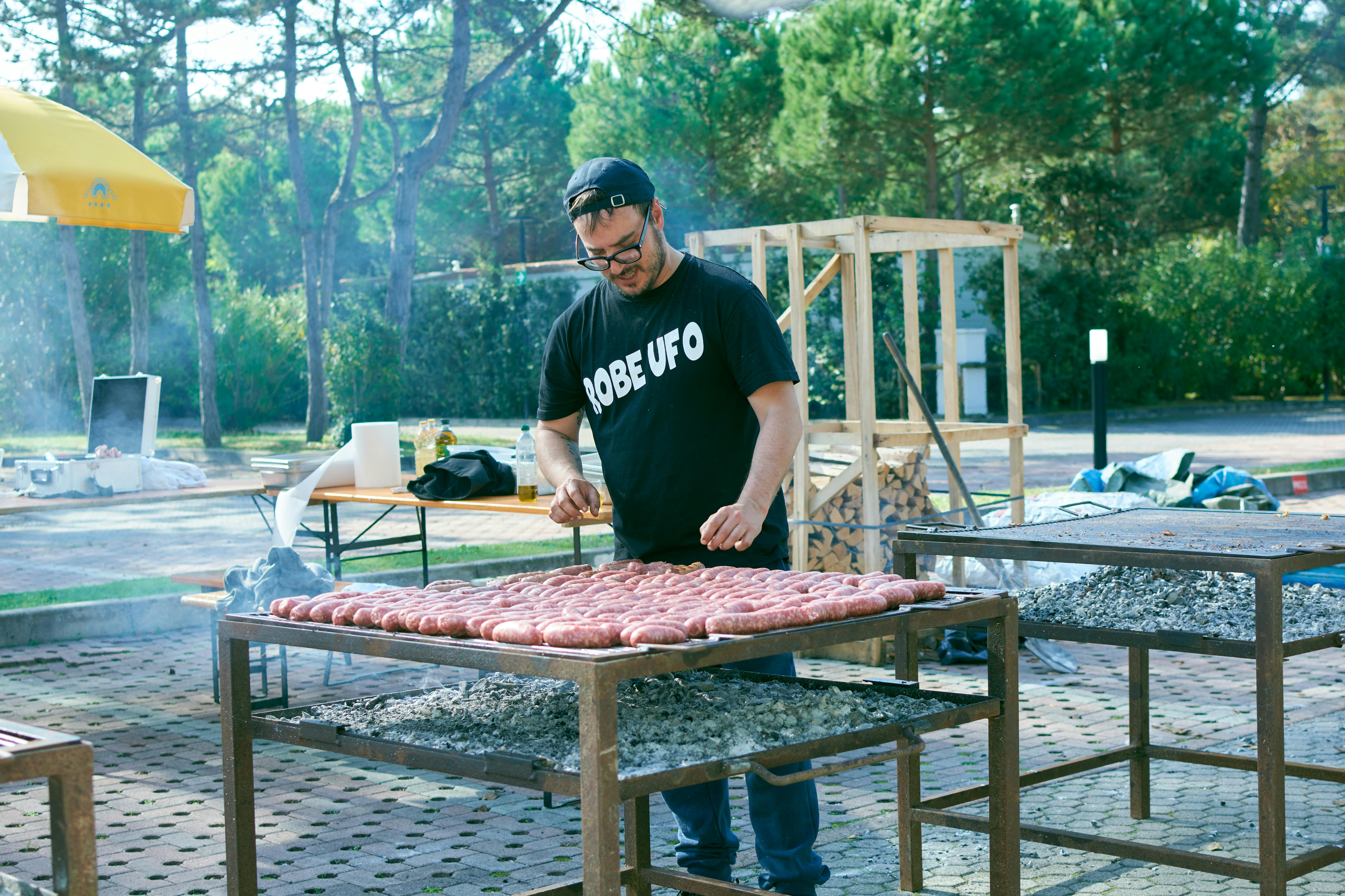 caterer loading food into a mobile cooler trailer at an outdoor event - emergency refrigeration storage