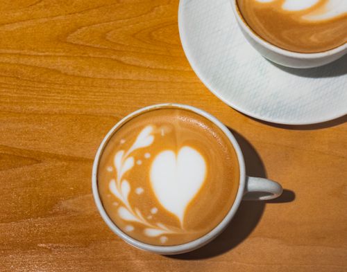 Free Close-up of heart-shaped latte art in a café, capturing the essence of Tokyo's coffee culture. Stock Photo