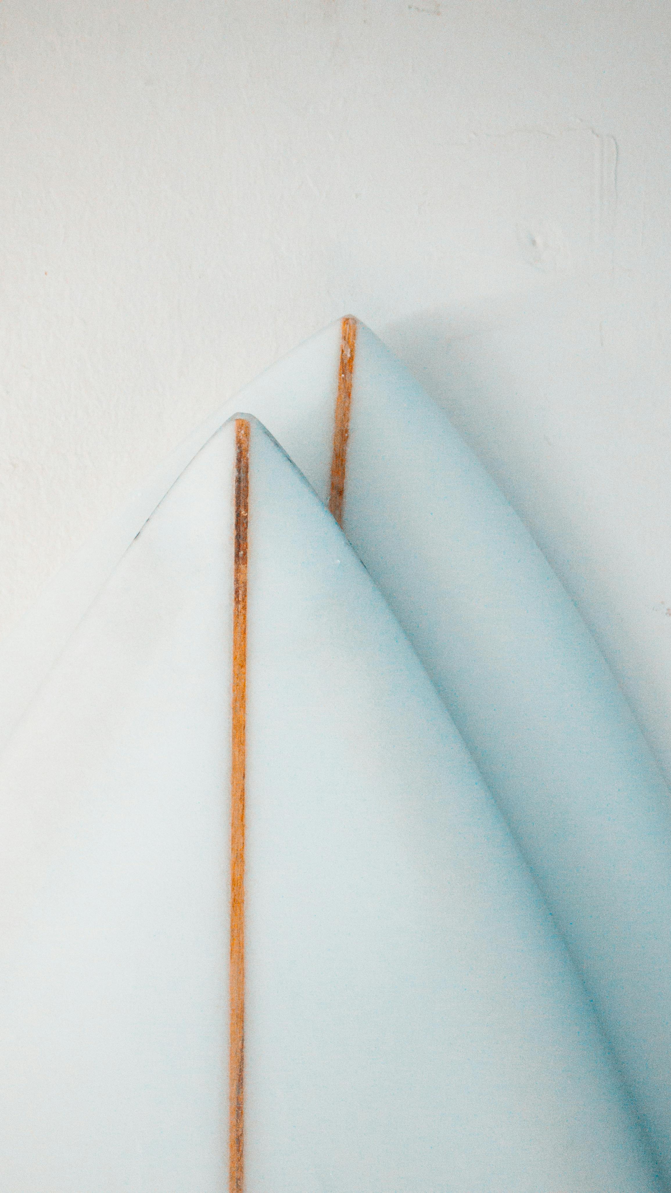 Free Two minimalist surfboards with wooden details leaned against a white wall, evoking a calm beach lifestyle. Stock Photo