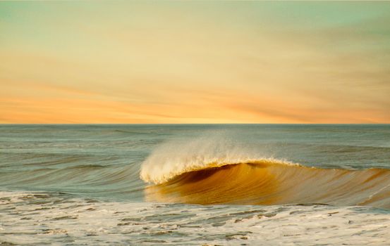 Captivating sunset over waves at Miramar Beach offering a tranquil scene.
