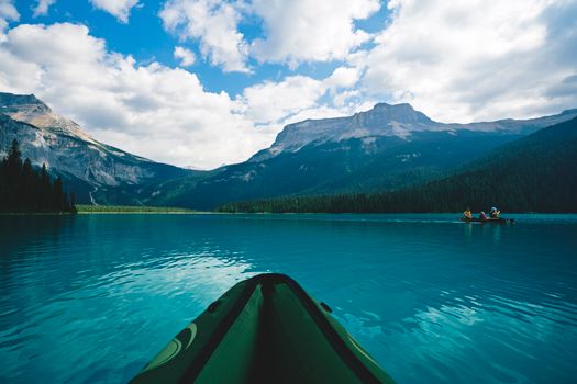 Explore the tranquility of kayaking across Emerald Lake, surrounded by majestic Canadian Rockies in summer.