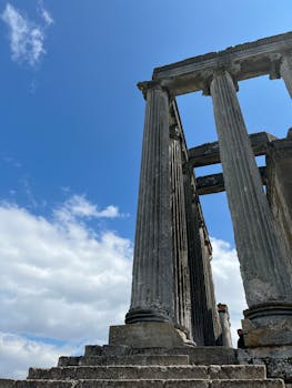 Explore the ancient temple ruins of Aizanoi in Kütahya, Türkiye, showcasing magnificent Greek architecture under a vibrant sky.