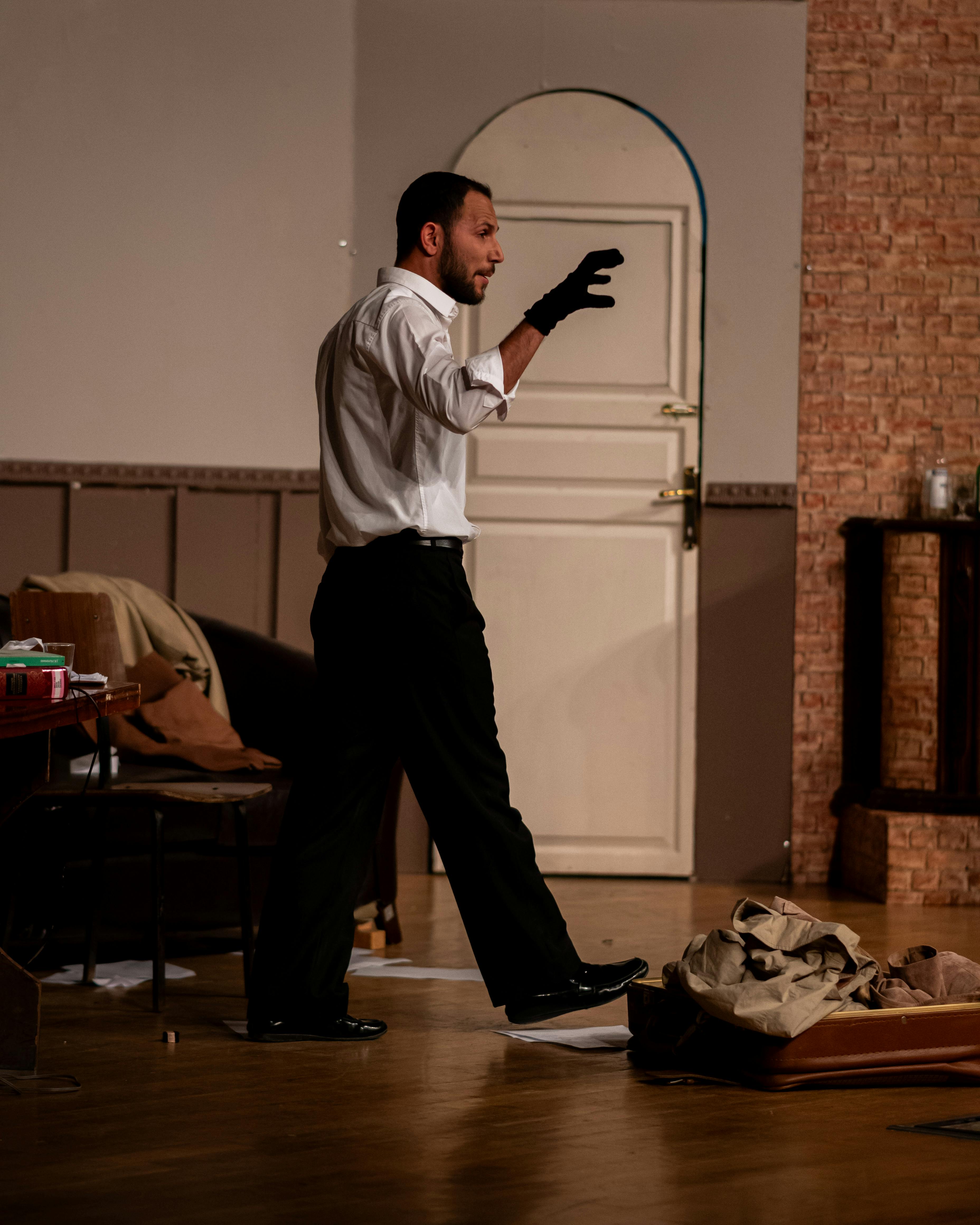Free Actor performs a dramatic role on stage with intense emotion in Kayseri theater. Stock Photo