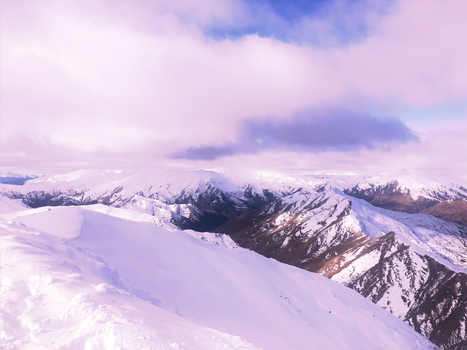 Scenic view of snow-covered mountains in Queenstown, Otago, New Zealand during winter.