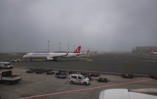 Free Turkish Airlines aircraft on a foggy runway at an airport, showcasing aviation transport. Stock Photo