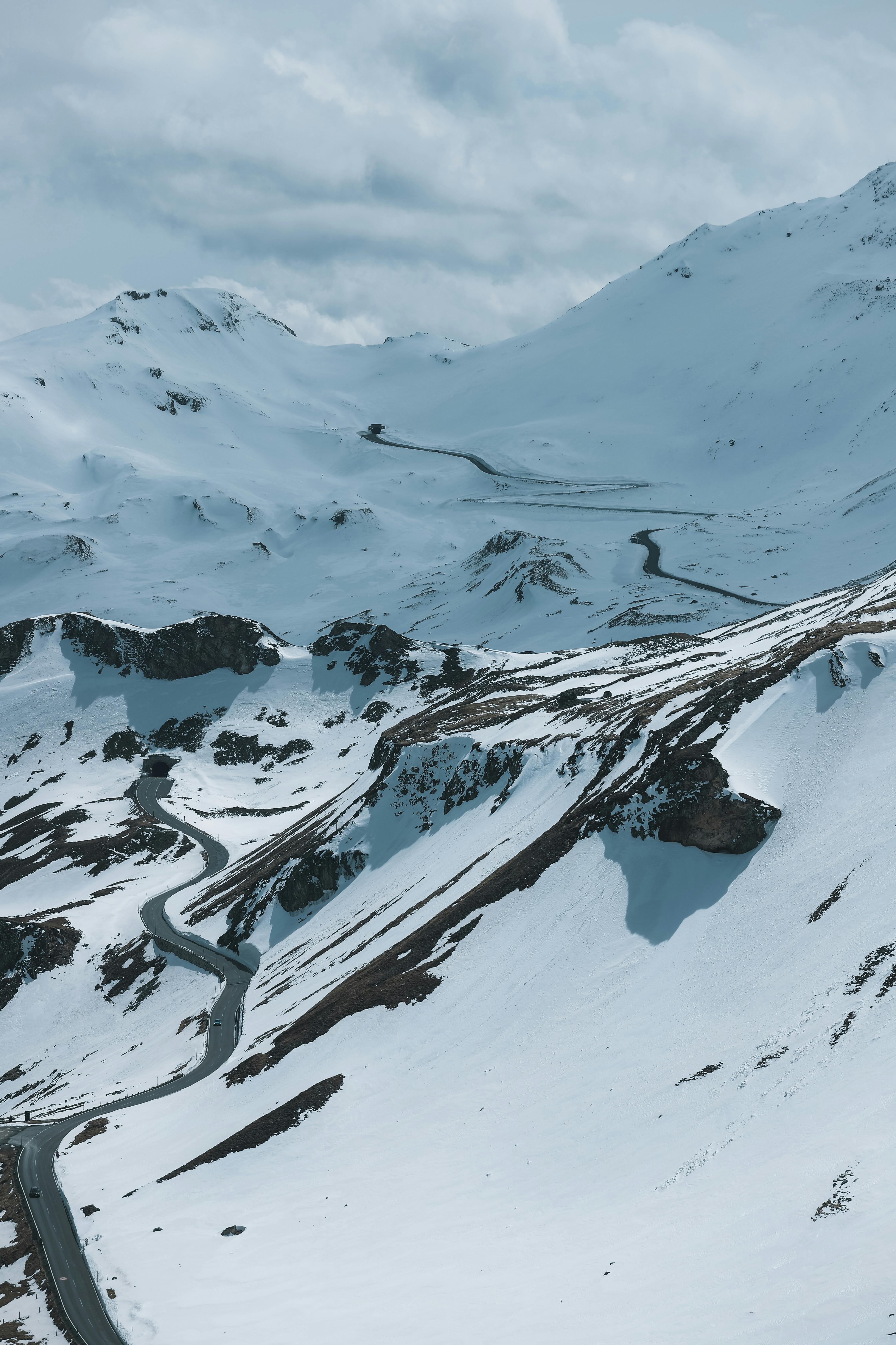 Breathtaking winter view of snowy mountains and winding roads in Salzburg, Austria.