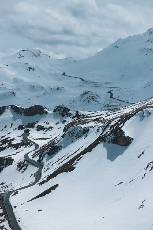 Free Breathtaking winter view of snowy mountains and winding roads in Salzburg, Austria. Stock Photo