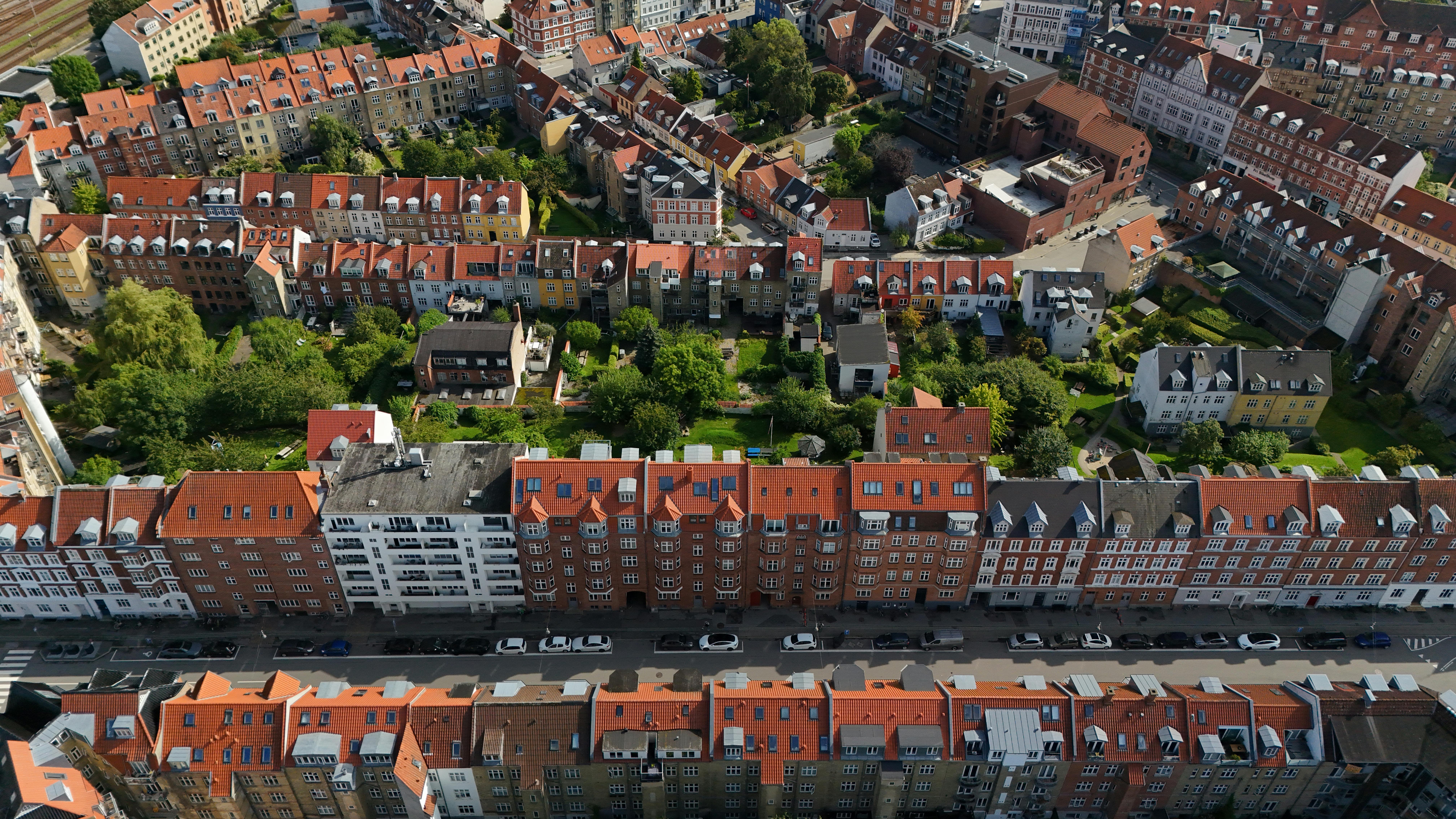 Aerial shot of Aarhus, Denmark showcasing residential architecture with red rooftops and greenery.