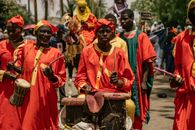 Vibrant street parade featuring African drummers in traditional attire. Perfect for cultural events.
