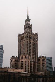 A grand clock tower standing tall against an overcast sky, showcasing architectural elegance.