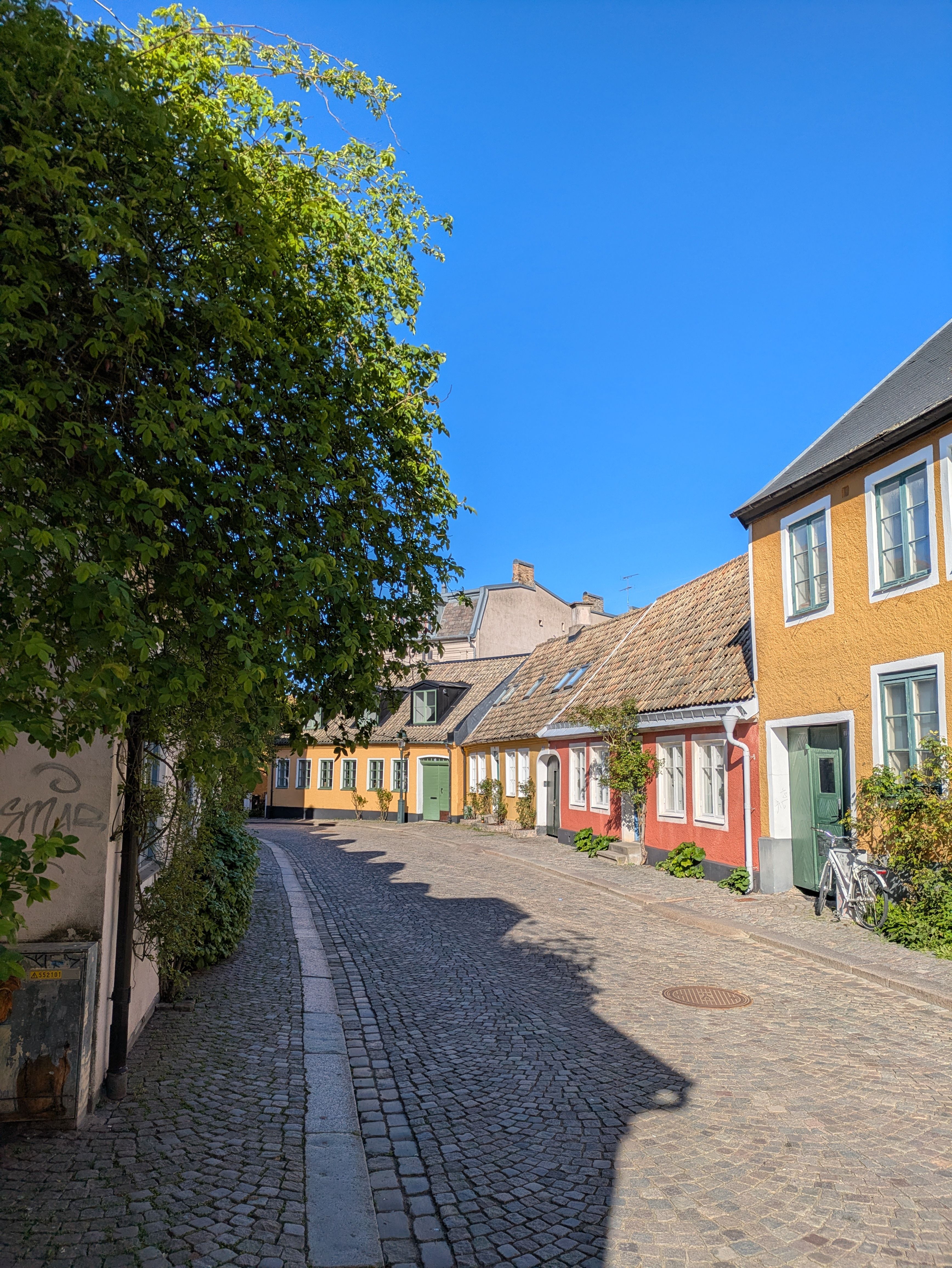 Charming Cobblestone Street with Colorful Houses · Free Stock Photo