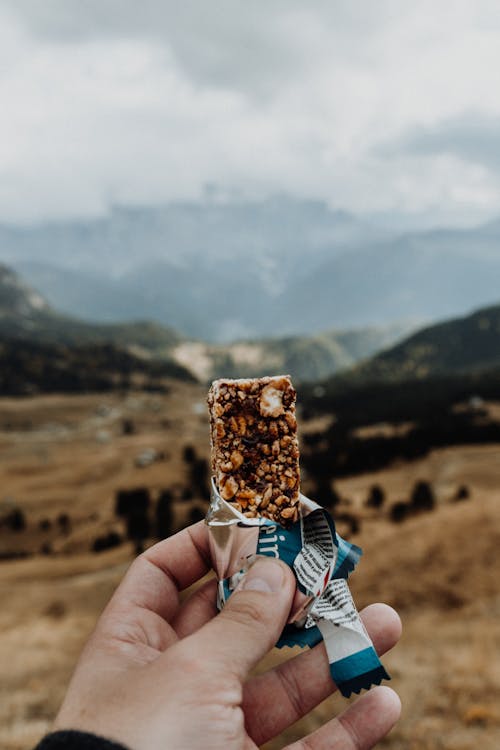 Free Photo of Person Holding a Cereal Bar Stock Photo