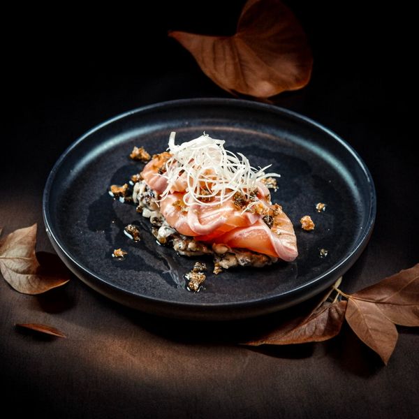 Ember-grilled seafood orzo on a dark plate — Patrick Bryan on Pexels