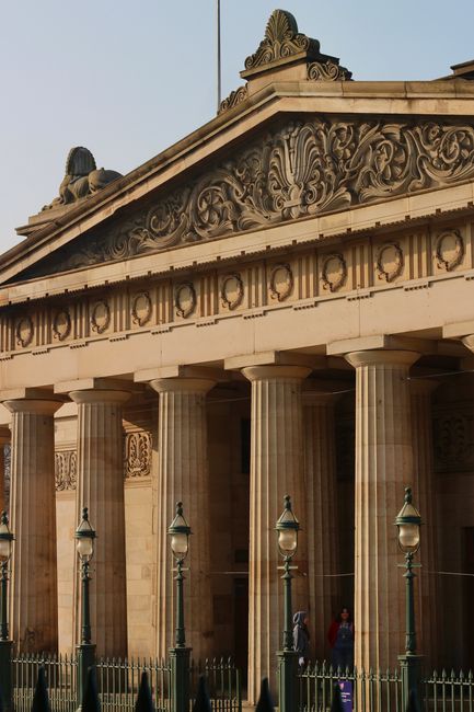 Close-up of a historic building with decorative pillars and ornate facade, showing detailed architecture.
