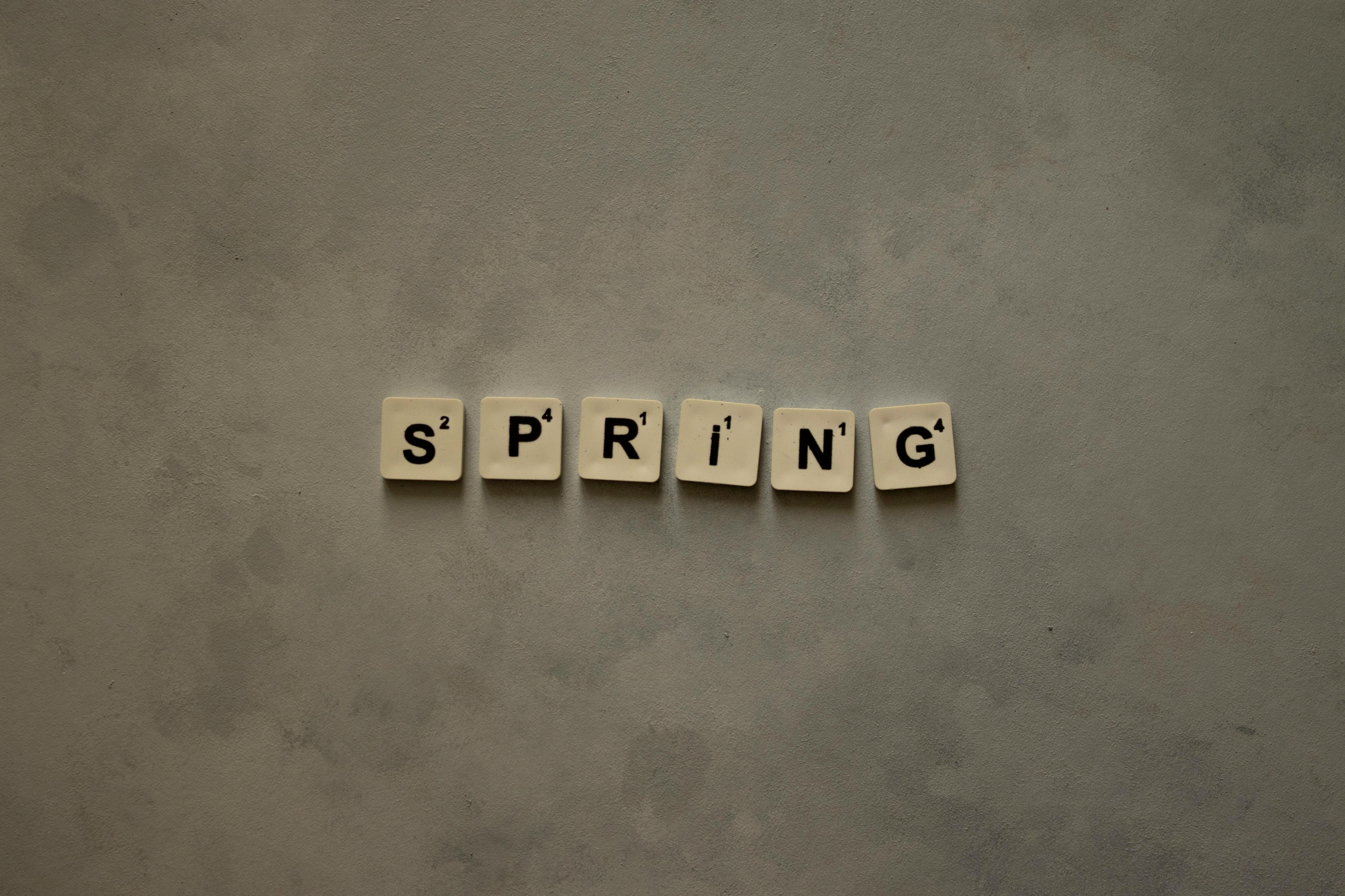 Scrabble Tiles Spell 'Spring' on Textured Background