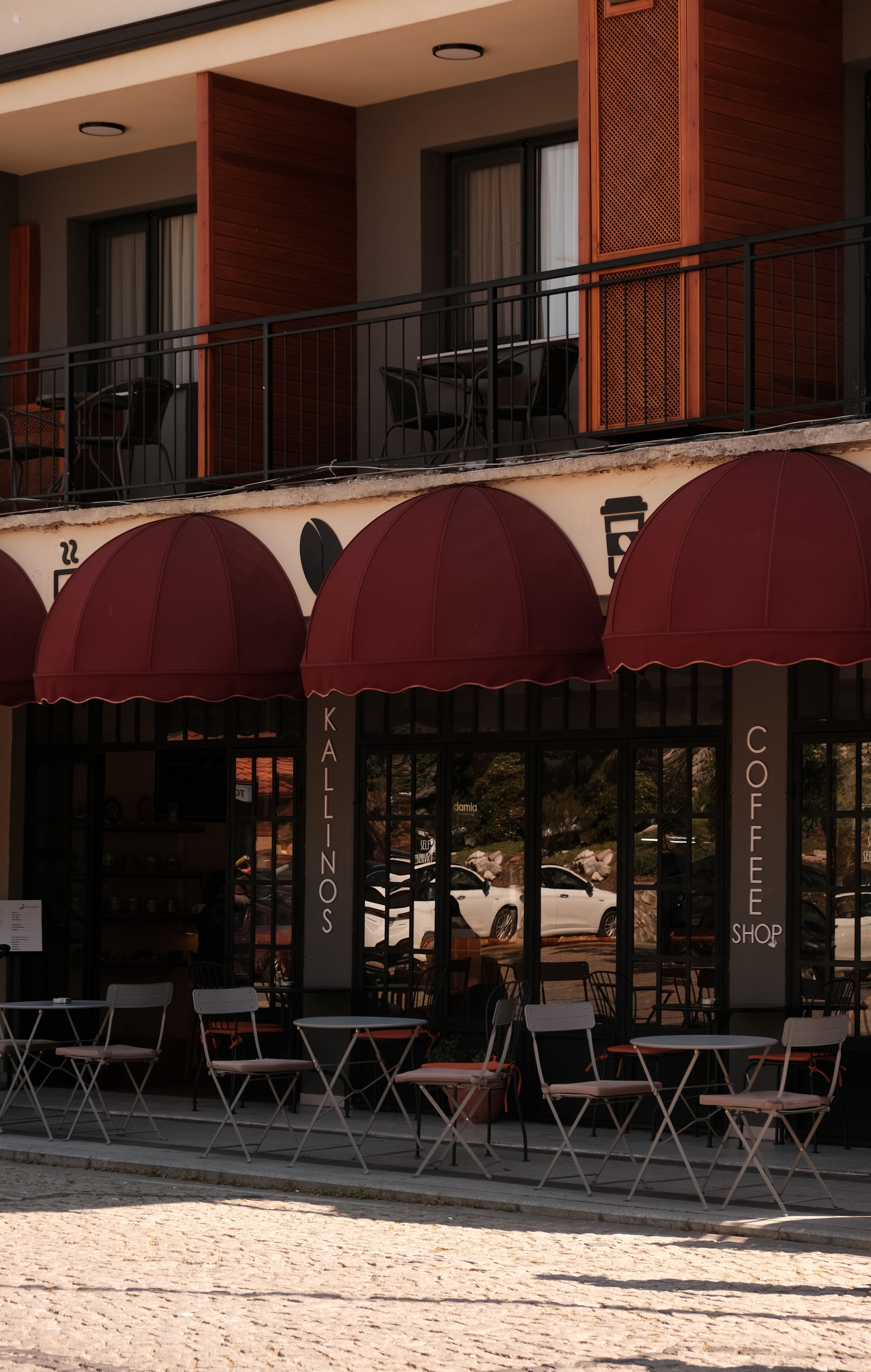 A quaint outdoor cafe with red awnings in Selçuk, İzmir, Türkiye.