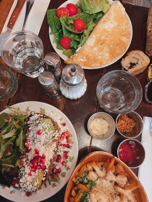 Free Top view of a table with various dishes including salad, omelette, toast, and condiments. Stock Photo