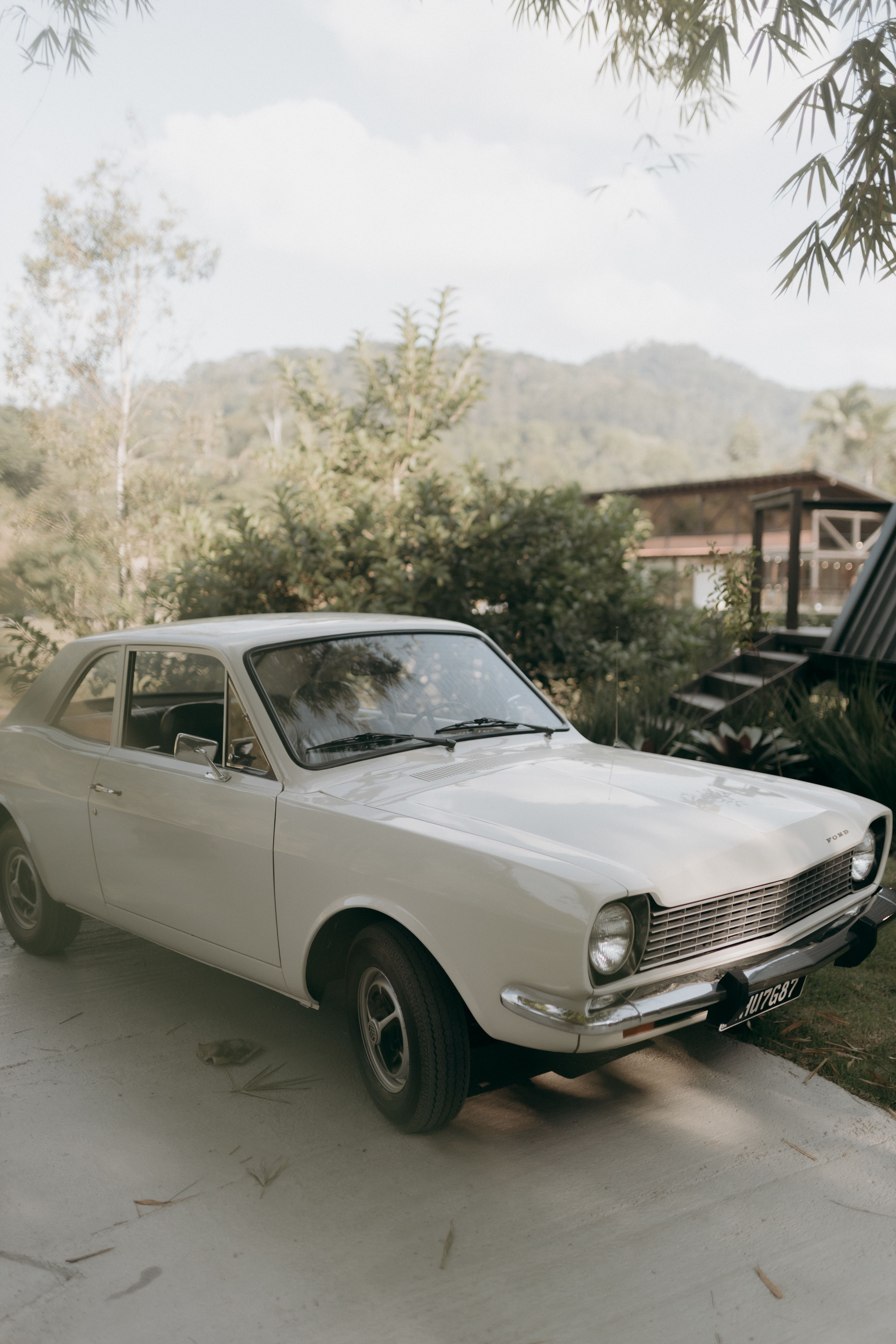 Vintage Car Parked in Rustic Outdoor Setting · Free Stock Photo