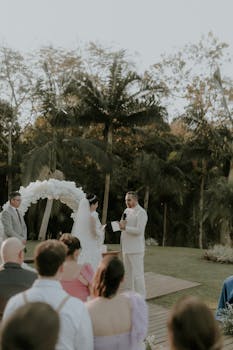 A beautiful outdoor wedding ceremony with bride and groom in tropical surroundings.