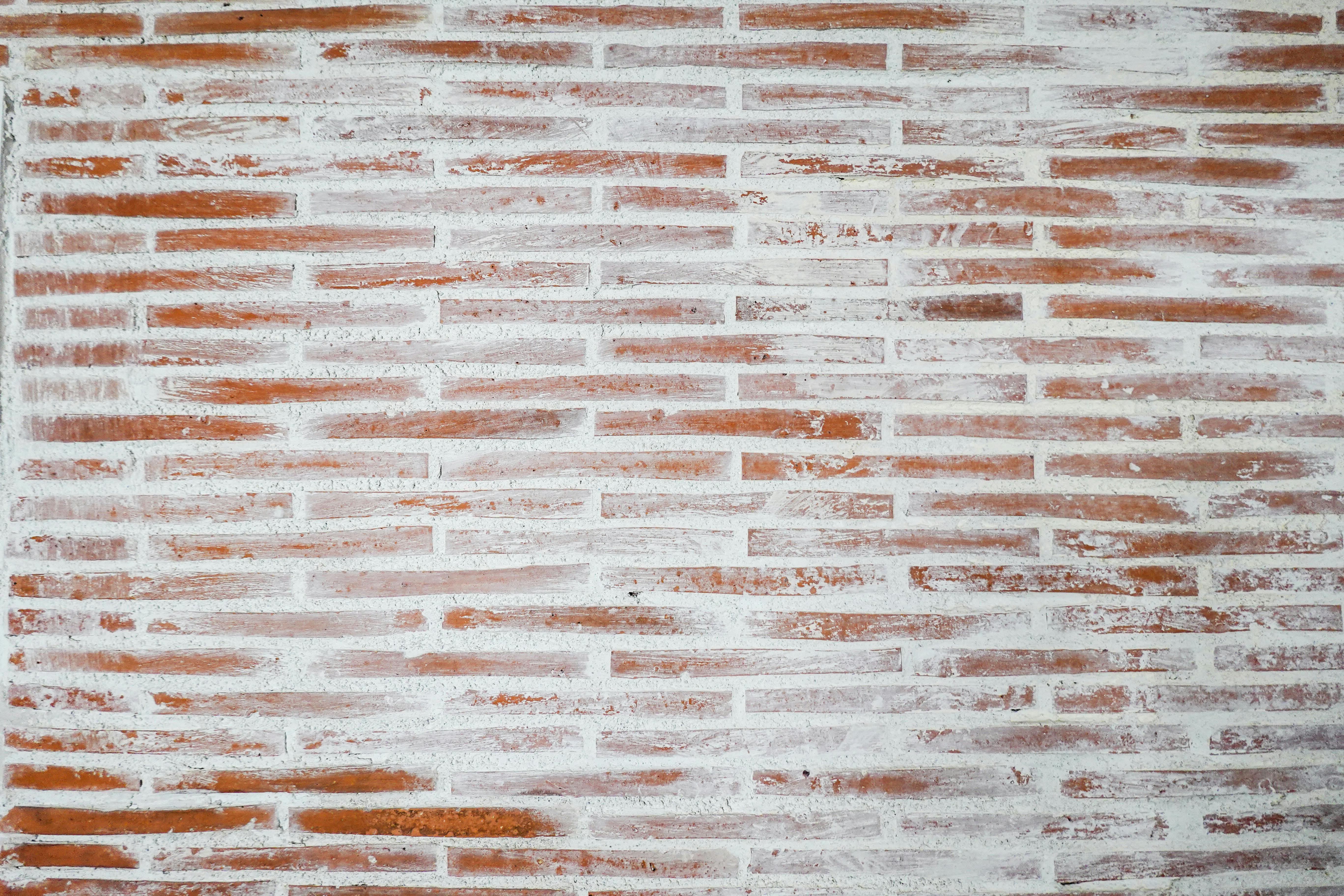 Free Textured red brick wall with white mortar, perfect for backgrounds and designs. Stock Photo