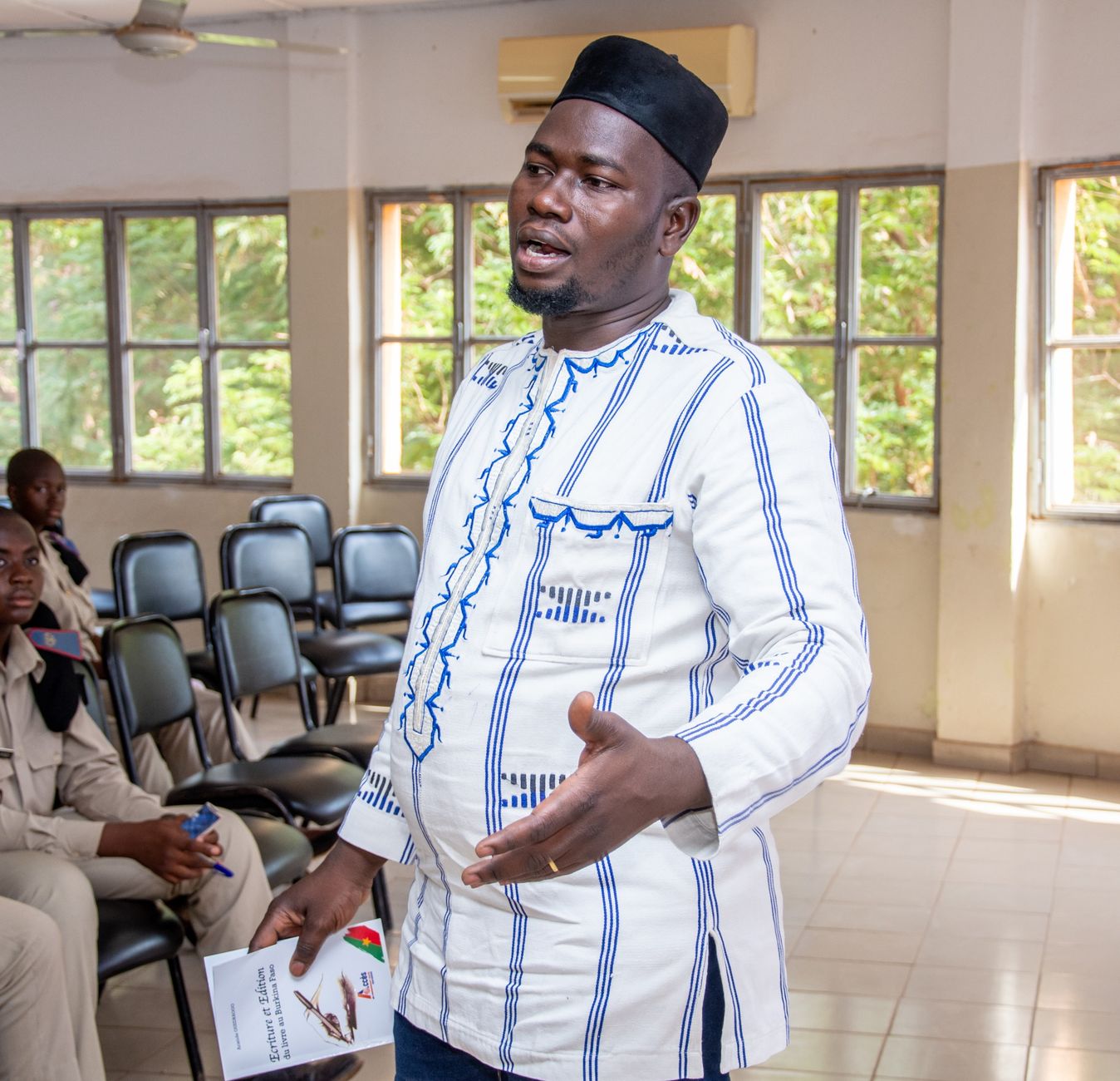 Confident man speaking passionately in a classroom setting.