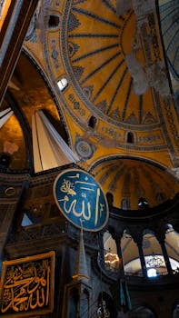 Stunning view of Hagia Sophia's intricate dome and Islamic calligraphy, Istanbul.