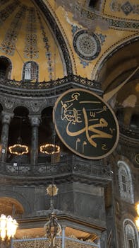 Detailed view of Hagia Sophia interior featuring stunning Arabic calligraphy and ornate architecture.