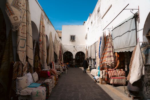 Browse vibrant textiles in a traditional outdoor market alley. Perfect for exploring cultural craftsmanship.
