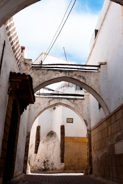 Free Explore the narrow ancient archway street in a historic medina, full of vintage charm. Stock Photo