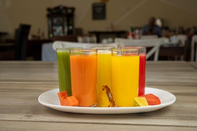 Colourful fresh fruit juices on a wooden table
