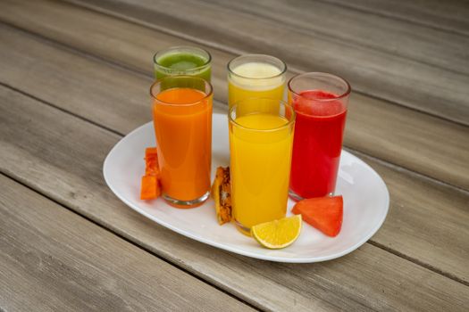 Vibrant assorted fruit juices served on a plate with fresh fruits in Salamanca.