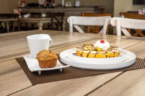 Free Start your day with coffee, muffin, and a sweet waffle breakfast in a Salamanca cafe. Stock Photo